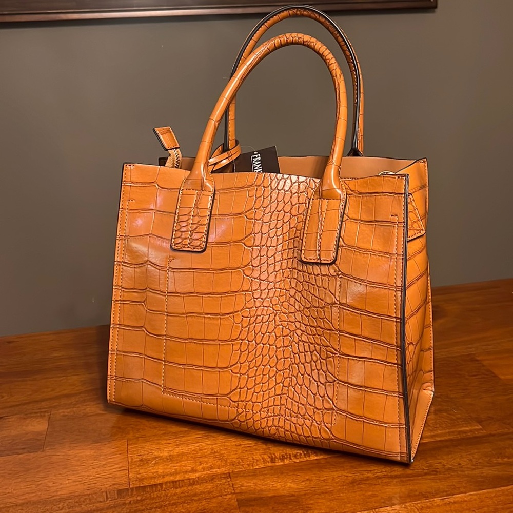 New with tags Frank Lyman hand bag.